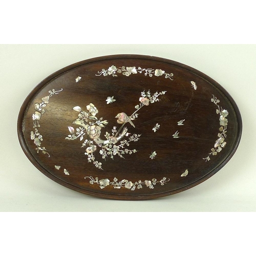 757 - A Japanese wooden oval tray, early 20th century, inlaid with birds and butterflies in mother of pear... 