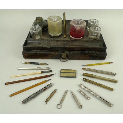 767 - An unusual table top pen tidy with six ink wells, brass handled drawer beneath, 30 by 21 by 12cm, to... 