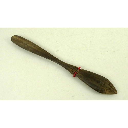 769 - A Papua New Guinea lime spatula, the handle with stylised zoomorphic face carved to either side, geo... 