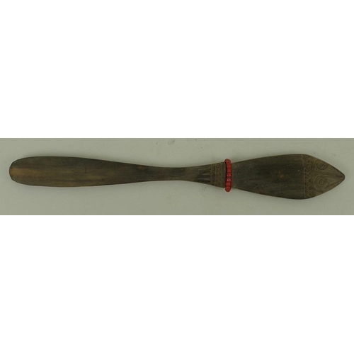 769 - A Papua New Guinea lime spatula, the handle with stylised zoomorphic face carved to either side, geo... 