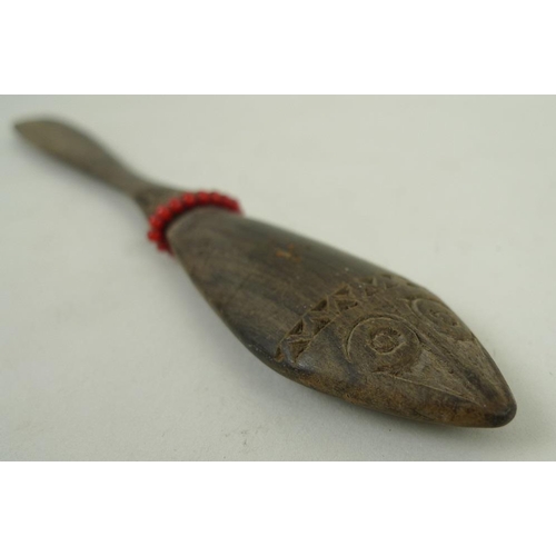 769 - A Papua New Guinea lime spatula, the handle with stylised zoomorphic face carved to either side, geo... 