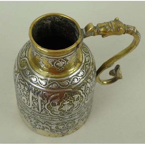 777 - A 19th century silver inlaid brass Persian Islamic ewer, with continuous scrolling silver calligraph... 