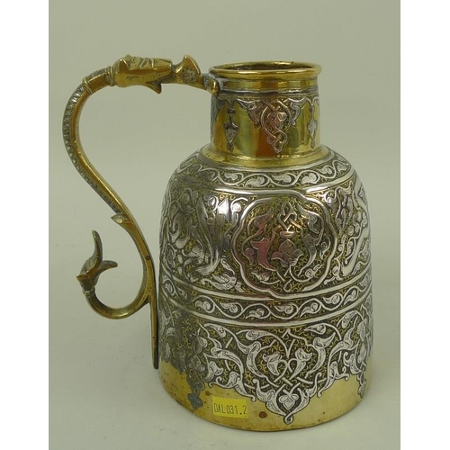 777 - A 19th century silver inlaid brass Persian Islamic ewer, with continuous scrolling silver calligraph... 