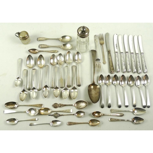 790 - A collection of silver wares including Georgian and later spoons, further flatware, and a silver top... 