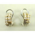 A pair of 18ct white gold and diamond earrings, the claw settings highlighted with yellow gold, each... 