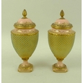 A pair of Victorian Coalport porcelain urns and covers, with pine cone finials, tapering circular se... 