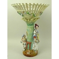 An Art Deco porcelain figural centrepiece, with pierced conical basket on a palm tree column and two... 