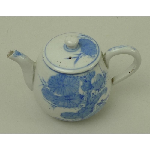 522 - A late 19th century Japanese teapot, the blue and white body decorated with swallows and chrysanthem... 