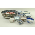 A group of Chinese and Japanese, ceramic bowls, 19th century and later, including tea bowls, one bel... 