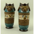 A pair of ceramic Egyptian revival vases with rams head handles, decorated in bands with hieroglyphs... 
