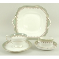 An Aynsley porcelain part dinner service, decorated with sage green bands to the rims, gilt detailin... 