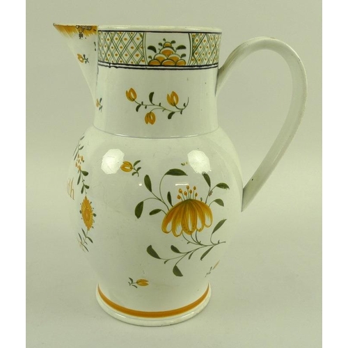 561 - An English pottery creamware jug, late 18th century, of baluster form, sparrow beak spout and strap ... 