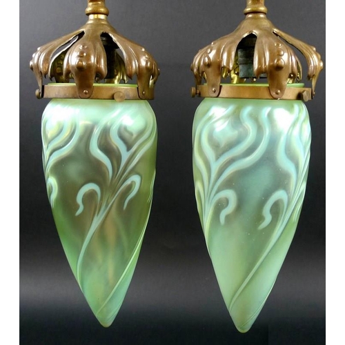 567 - A pair of Art Nouveau vaseline glass shades, of slender teardrop form, with floral decoration, open ... 