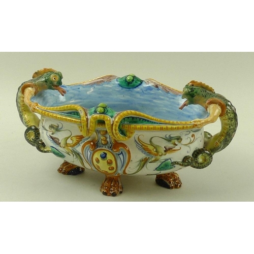 568 - A faience Cantagalli majolica centrepiece, Italian, with salamander handles, raised on four lions pa... 