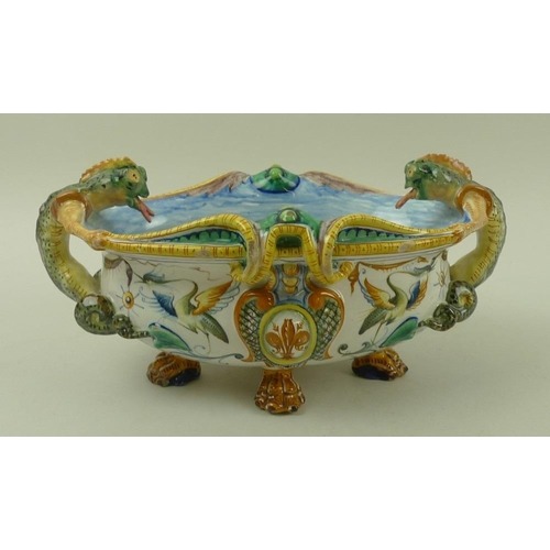 568 - A faience Cantagalli majolica centrepiece, Italian, with salamander handles, raised on four lions pa... 