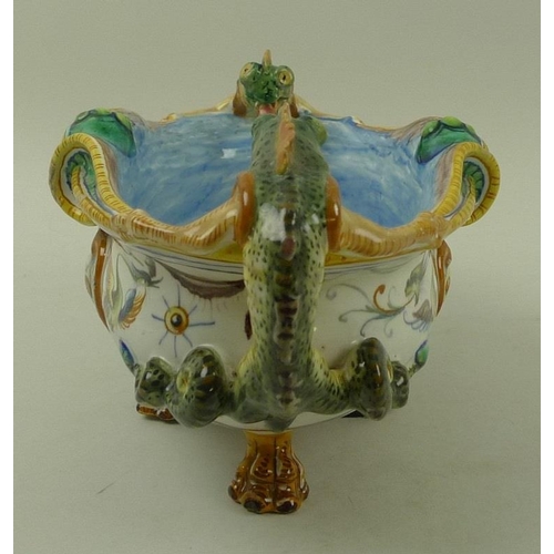 568 - A faience Cantagalli majolica centrepiece, Italian, with salamander handles, raised on four lions pa... 