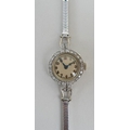 An Art Deco platinum and diamond Vertex lady's cocktail wristwatch, circular champagne face with gol... 