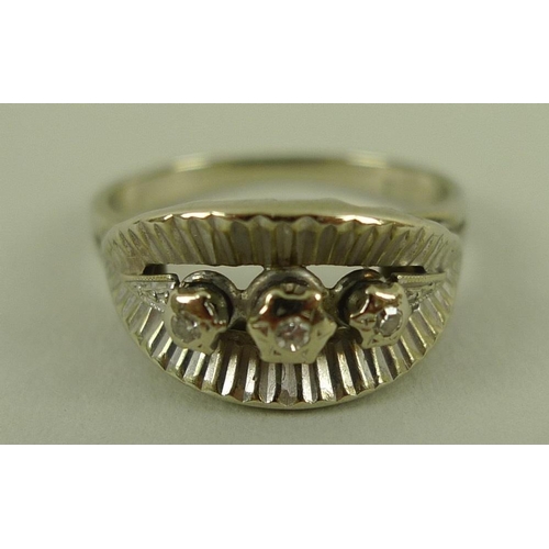 818 - An 18ct gold and diamond dress ring of modernist design set with three diamonds, size M, 4.6g.