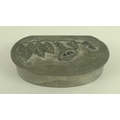 An Art Deco pewter trinket box, of oval lidded form decorated in low relief with a convulvulus, sign... 