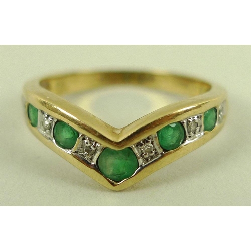 824 - A diamond and emerald dress ring, in chevron format, five emeralds mounted alternately by six illusi... 