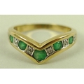 A diamond and emerald dress ring, in chevron format, five emeralds mounted alternately by six illusi... 