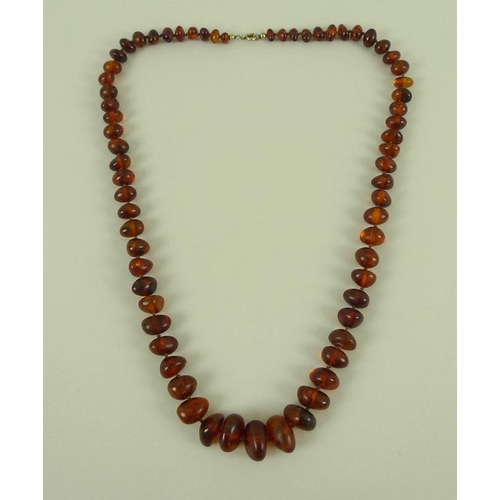 830 - A vintage amber bead necklace, of clear treacle colour with some inclusions, 63cm long, beads gradua... 