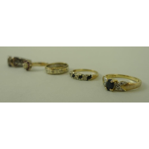 831 - A group of three 9ct gold rings, comprising a diamond and sapphire ring, a ruby and diamond ring, bo... 