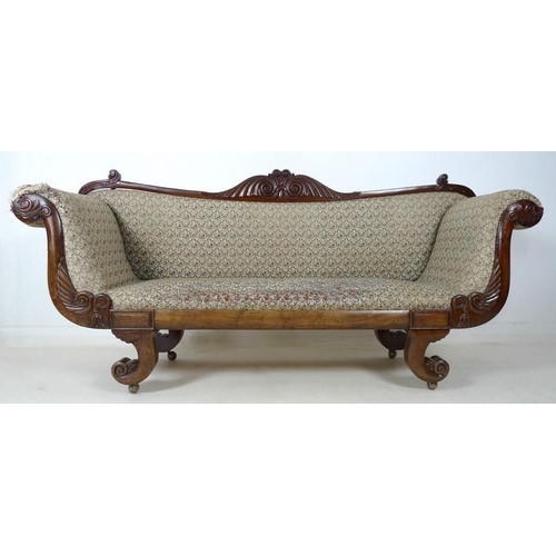 928 - A Regency mahogany scroll end settee, with carved and shaped back, foliate carvings to the front of ... 