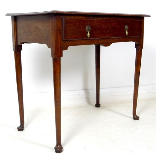 929 - A George I oak lowboy, with single drawer, brass drop handles, raised on turned and tapering legs wi... 