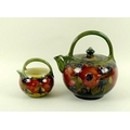 A Moorcroft Pomegranate pattern teapot with green ground, ovoid form, marked to the base in green, 1... 