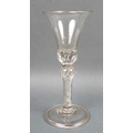 A George II wine glass, the bell shaped bowl above a single knopped multi air twist stem extending i... 