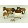 A group of Beswick figurines, formed as donkeys, comprising three adults and a foal, together with a... 