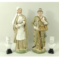 A pair of bisque figurines depicting a wounded Boer War soldier, and a nurse, 23cm, and a pair of pa... 