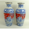 A pair of 19th century vases, decorated in transfer blue with iron red sky, each 38cm high. (2)