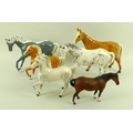 A group of five Royal Doulton figurines, each modelled as a horse, comprising two unglazed and parti... 