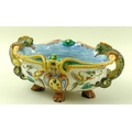 A faience Cantagalli majolica centrepiece, Italian, with salamander handles, raised on four lions pa... 