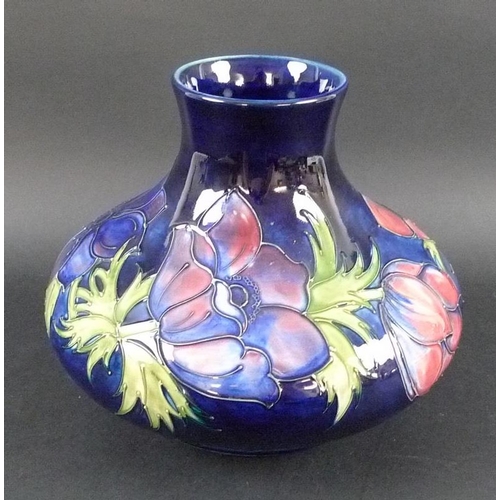 568 - A large Moorcroft pottery vase, of squat form, decorated in the Anemone pattern against an indigo gr... 