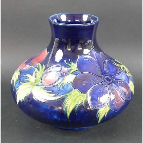 568 - A large Moorcroft pottery vase, of squat form, decorated in the Anemone pattern against an indigo gr... 