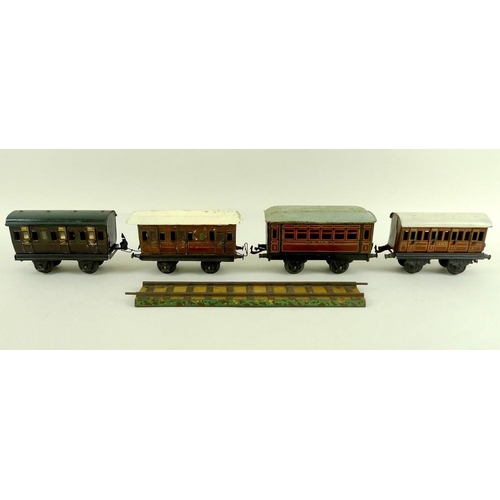 700 - A group of O gauge tinplate coaches, early 20th century, comprising two Marklin passenger coaches, w... 