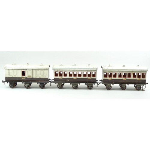 710 - A group of three large scale 2.75 inch coaches, circa 1930, comprising two First Class passenger coa... 