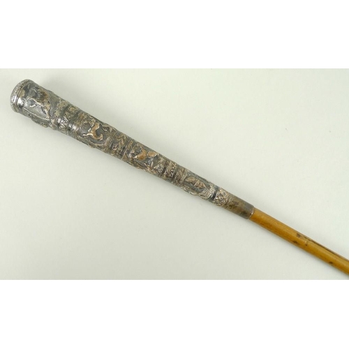 808 - A Burmese white metal parasol handle embossed with bands of tigers, elephants, huts, birds and snake... 