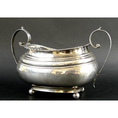 814 - An usually large Georgian silver sucrier, the boat shaped body with ribbed shoulders, lappet and bea... 