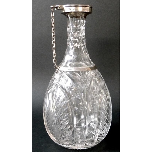 815 - An George V silver mounted cut glass claret jug, with oval-shaped cut-glass body, silver 'trap' lid ... 