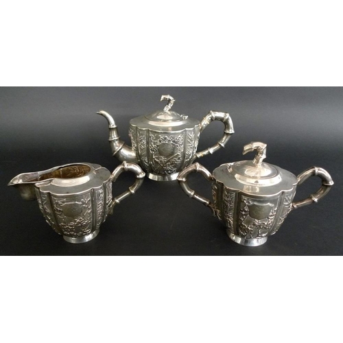 818 - A Chinese Export silver three piece tea service, late 19th century, each of vertical fluted form wit... 