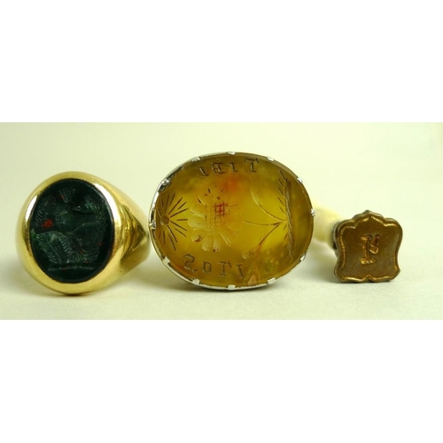 819 - A bloodstone intaglio seal set in an 18ct gold signet ring, size P, 13.3g, a silver set onyx intagli... 