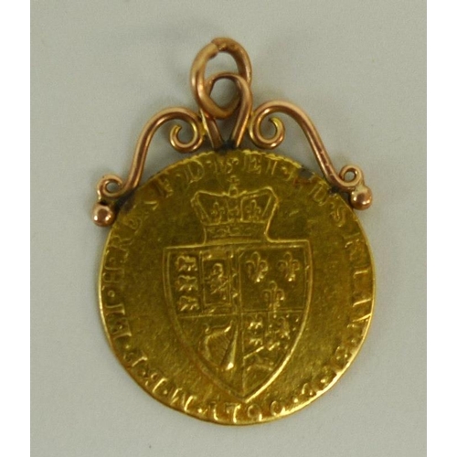 832 - A George III gold guinea, dated 1790, with later attached scrolling pendant loops, 9.3g.