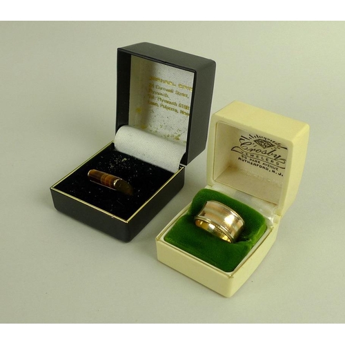 837 - An 18ct gold ring set with a cylinder cut tiger's eye, size 'L', 6.4g, together with a 14ct gold tri... 