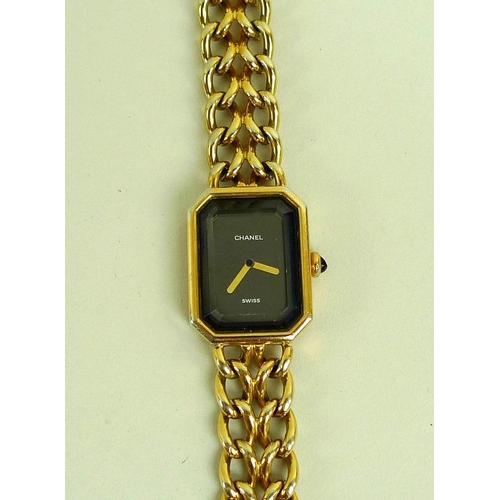 841 - A lady's gold plated Chanel watch, circa 1990, with black rectangular face with canted corners, gold... 