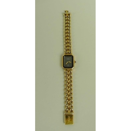 841 - A lady's gold plated Chanel watch, circa 1990, with black rectangular face with canted corners, gold... 