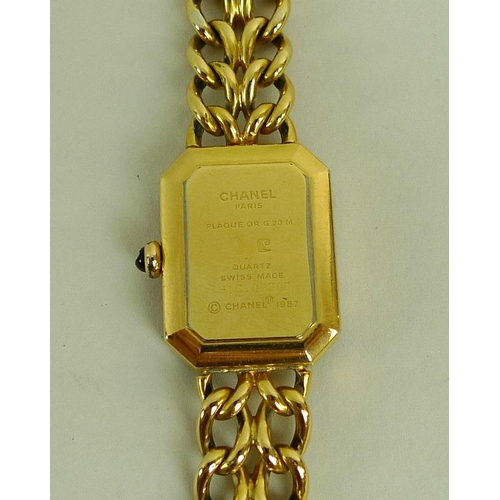 841 - A lady's gold plated Chanel watch, circa 1990, with black rectangular face with canted corners, gold... 